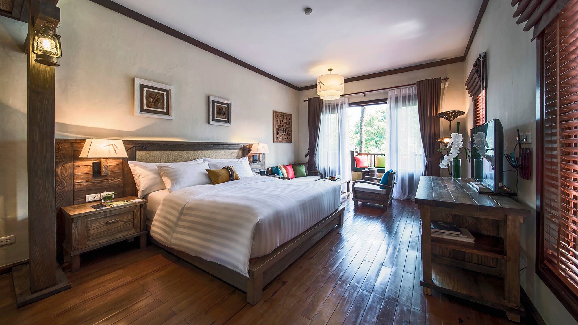 a bedroom with a bed and a wood floor