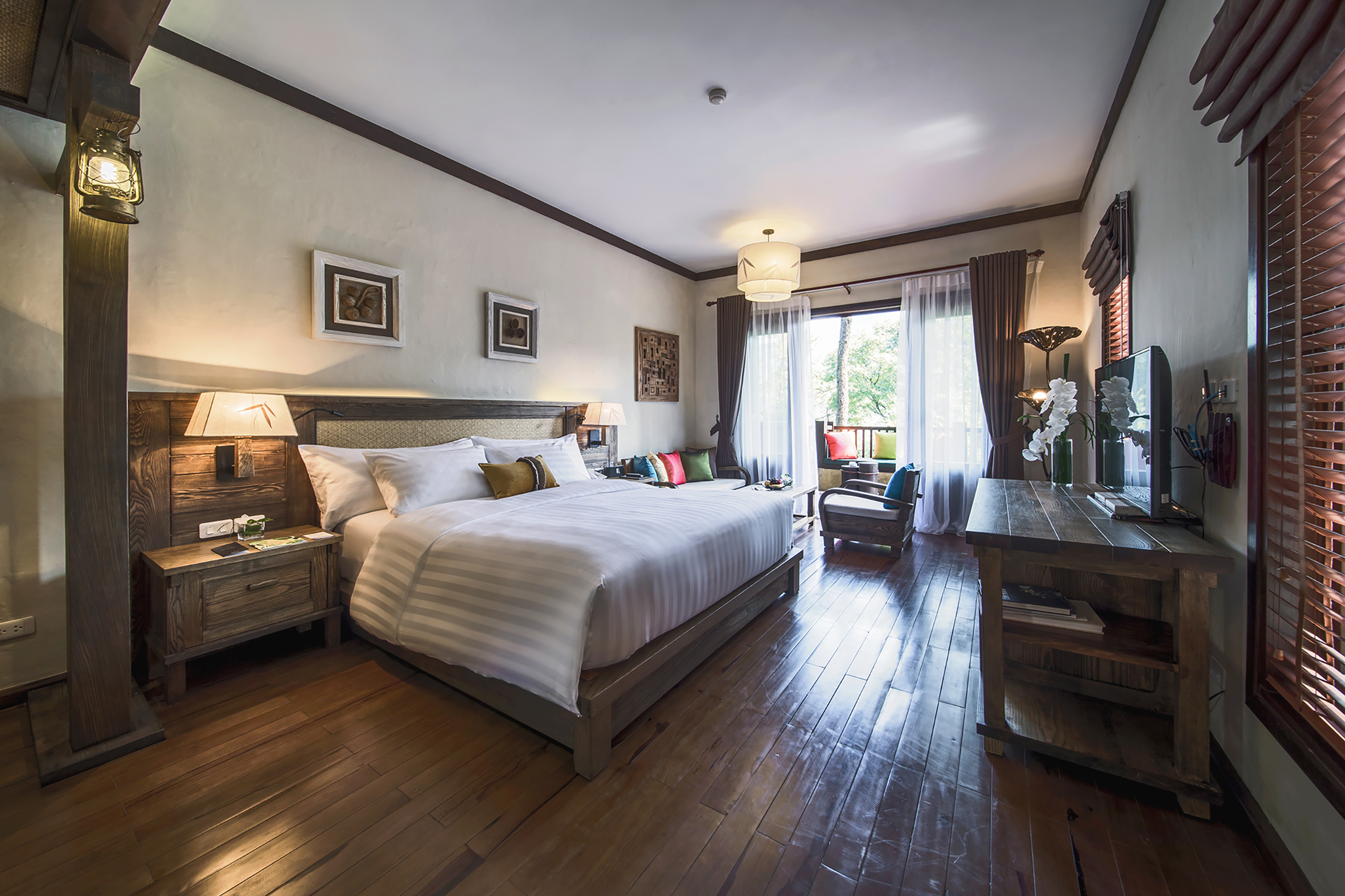 a bedroom with a bed and a wood floor