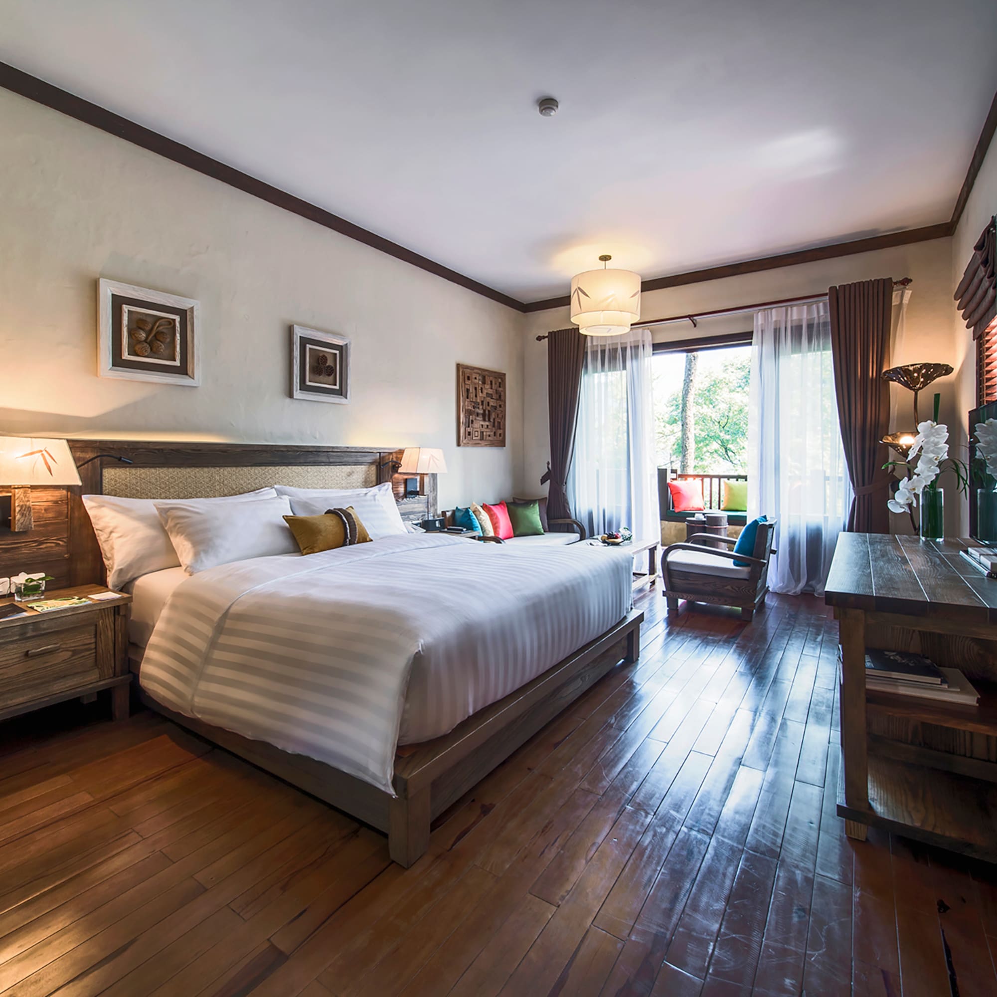 a bedroom with a bed and a wood floor