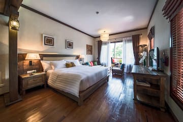 a bedroom with a bed and a wood floor