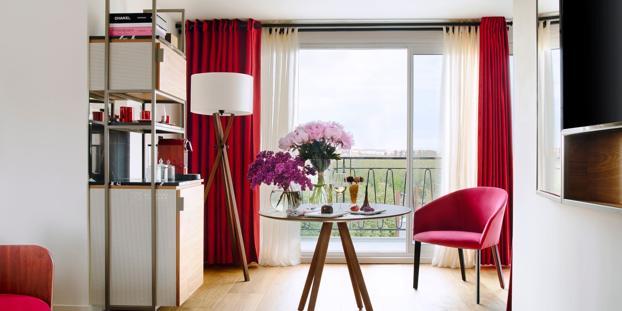 a room with a table and chairs and a window