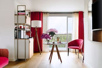 a room with a table and chairs and a window