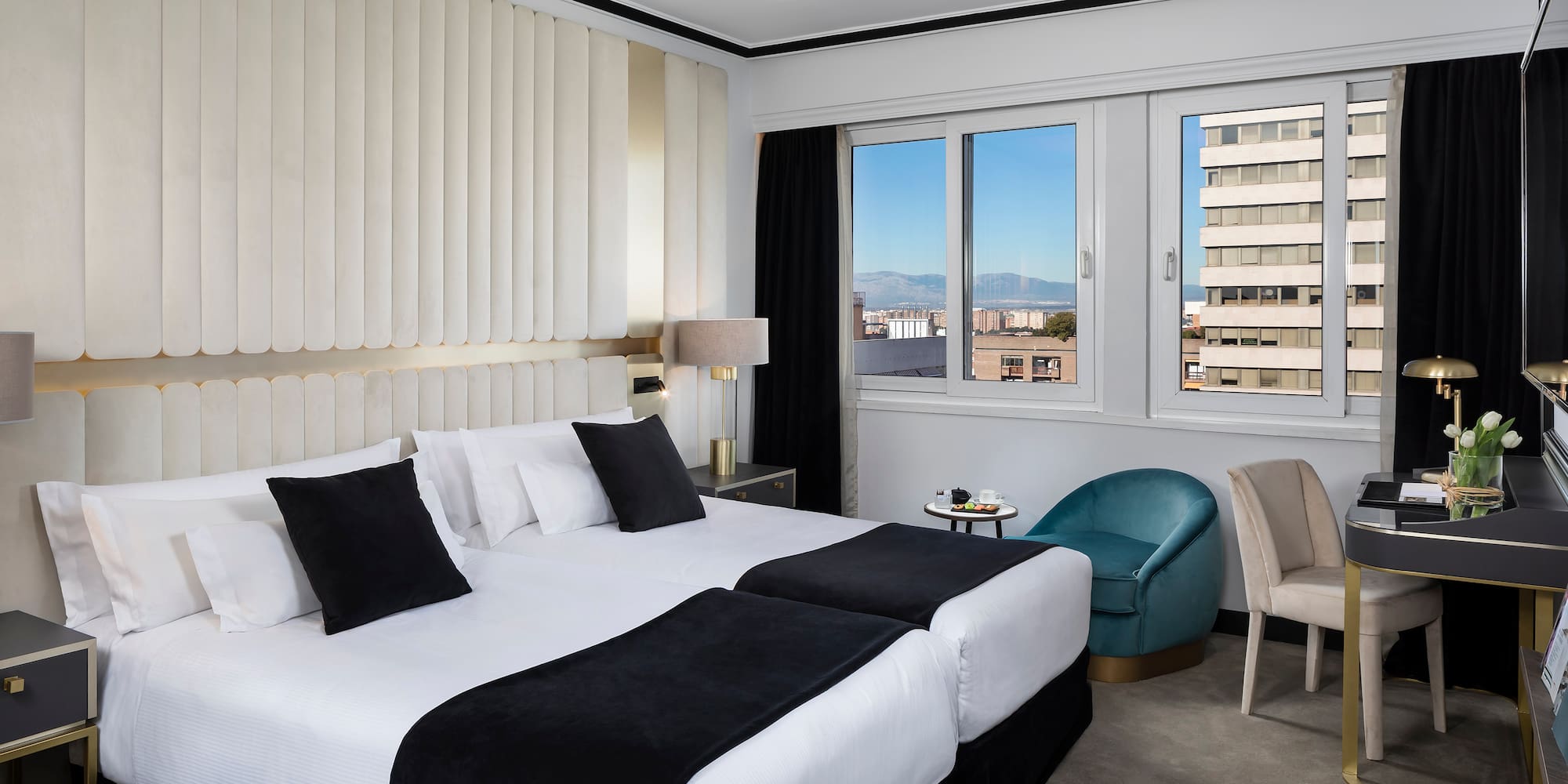 a hotel room with two beds and chairs