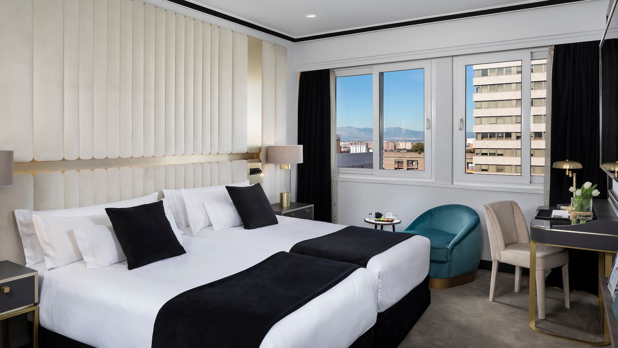 a hotel room with two beds and chairs