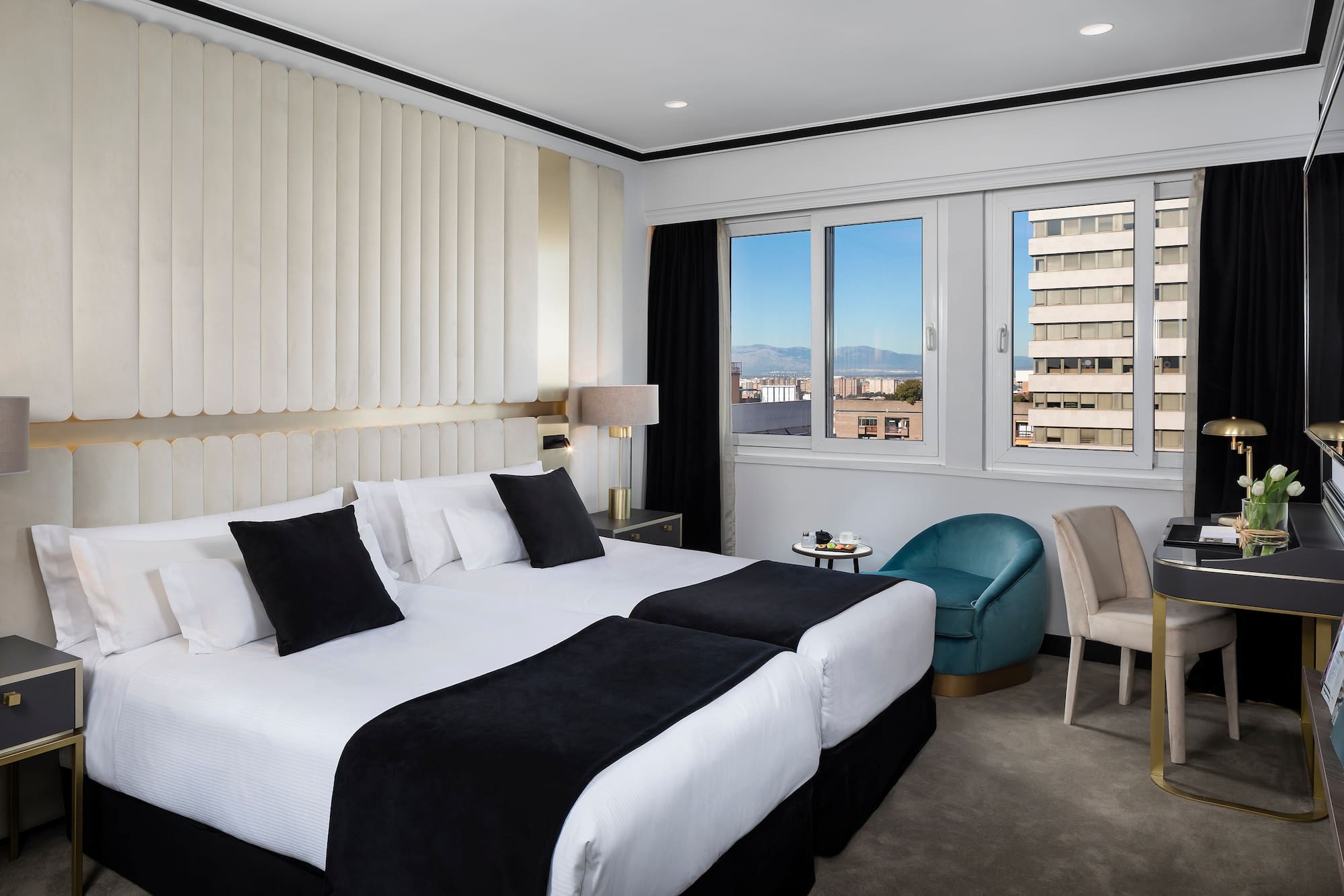 a hotel room with two beds and chairs