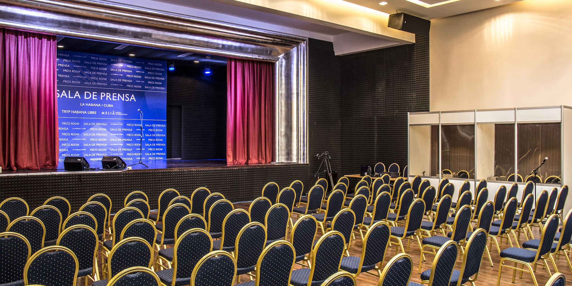 a room with rows of chairs and a stage