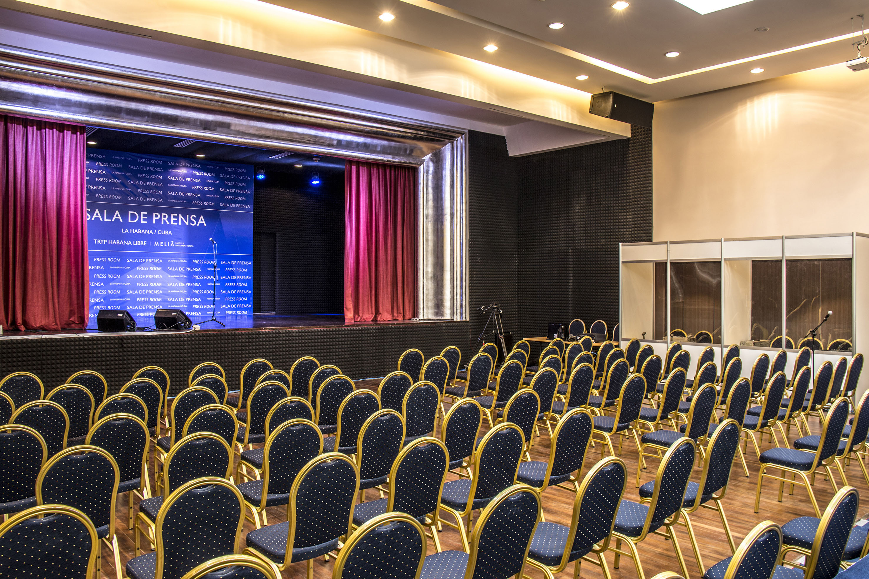 a room with rows of chairs and a stage