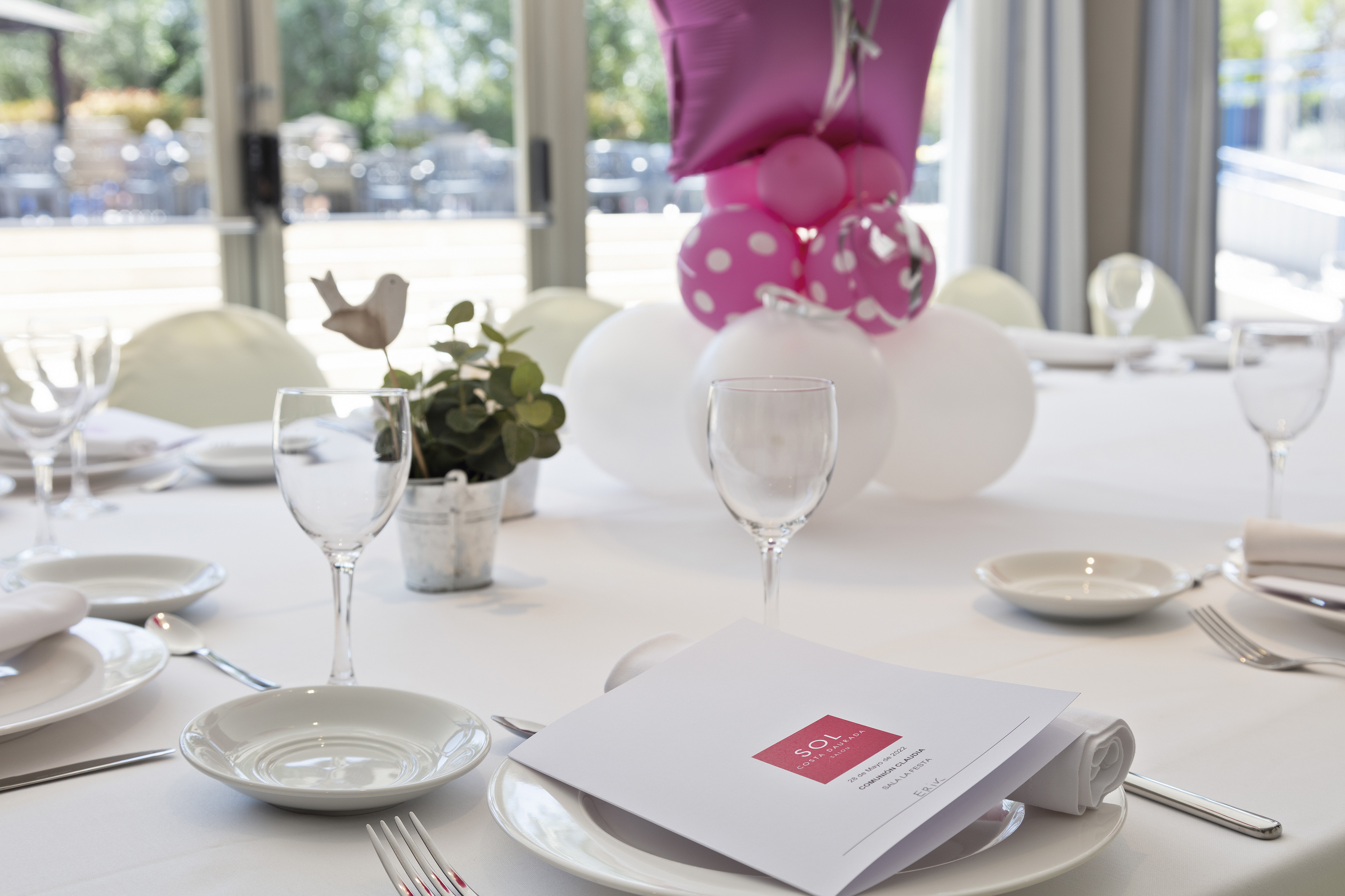 a table with plates and glasses and a balloon