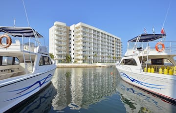 a group of boats in water next to a building