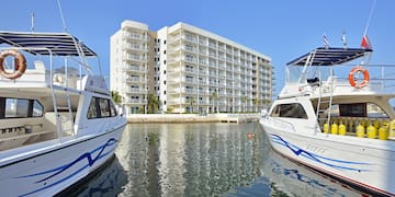 a group of boats in water next to a building