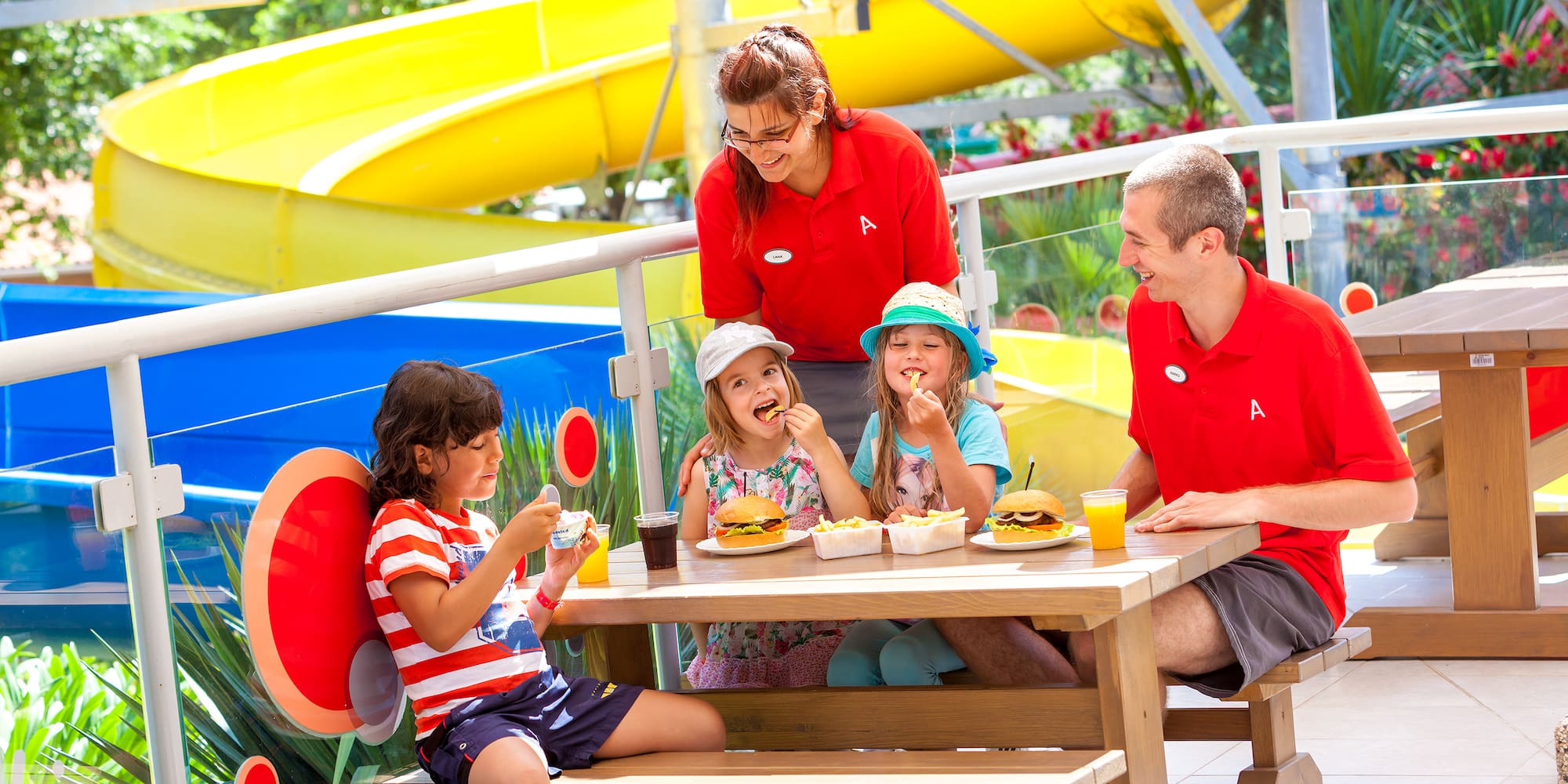 a group of people eating at a picnic table