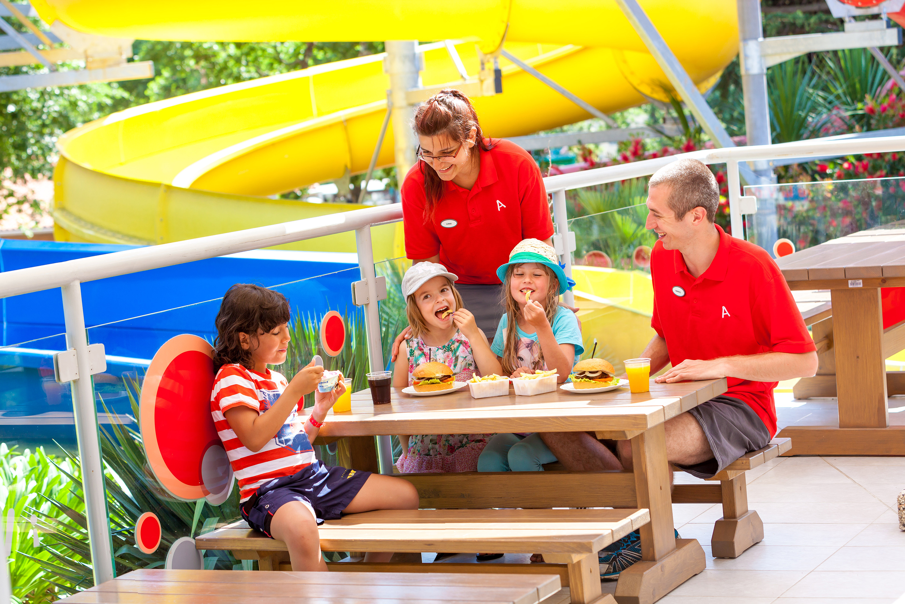 a group of people eating at a picnic table