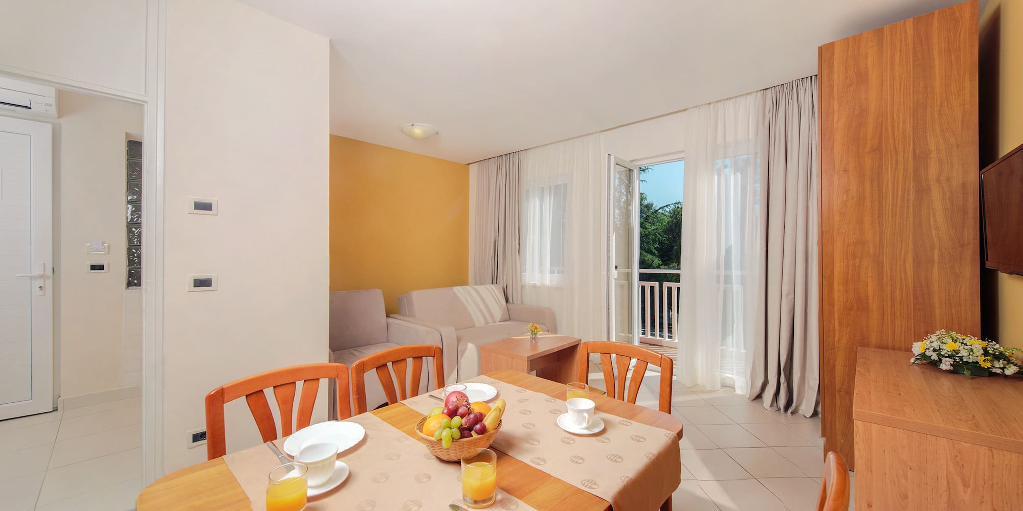 a room with a table and chairs and a couch