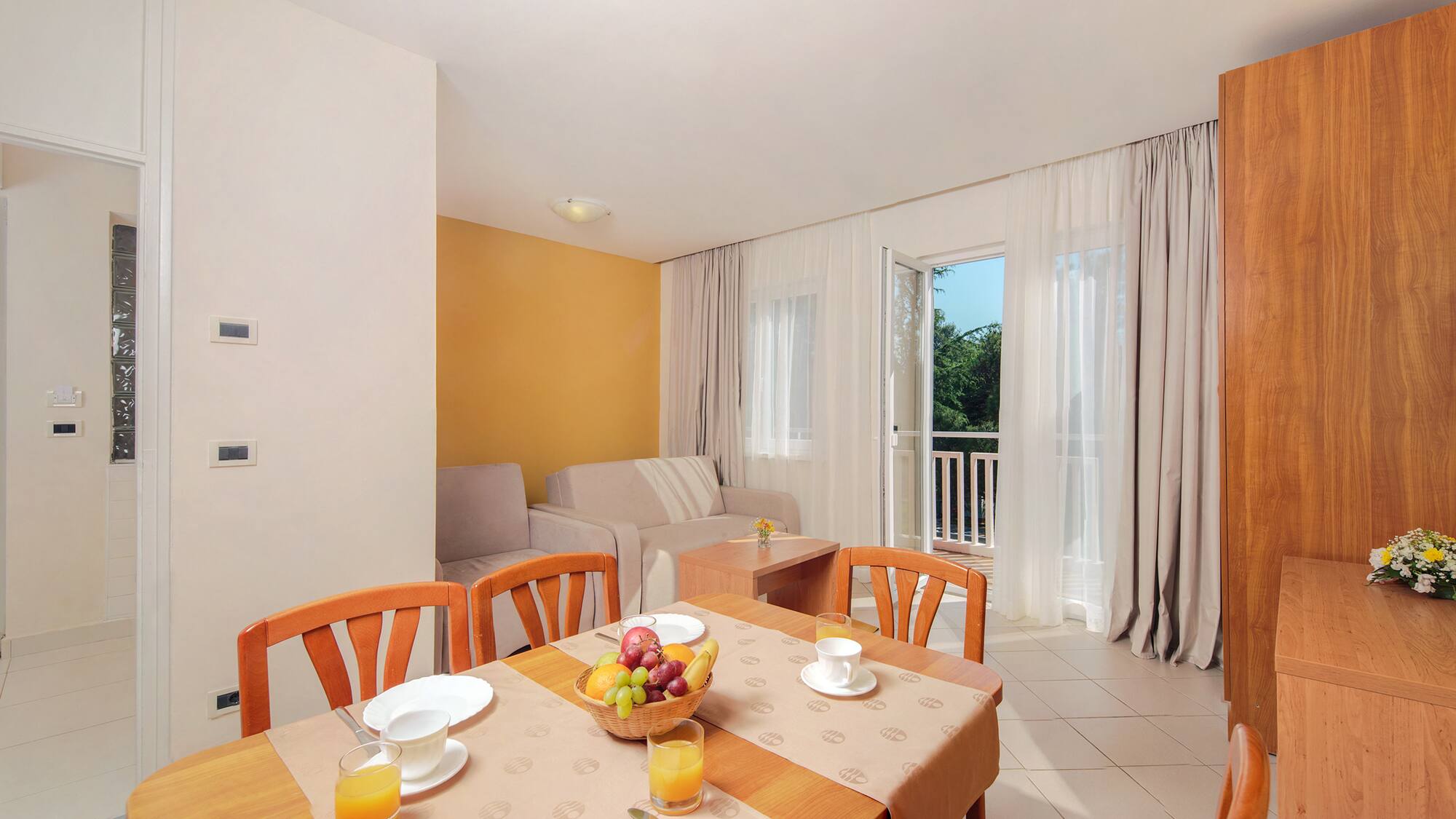 a room with a table and chairs and a couch