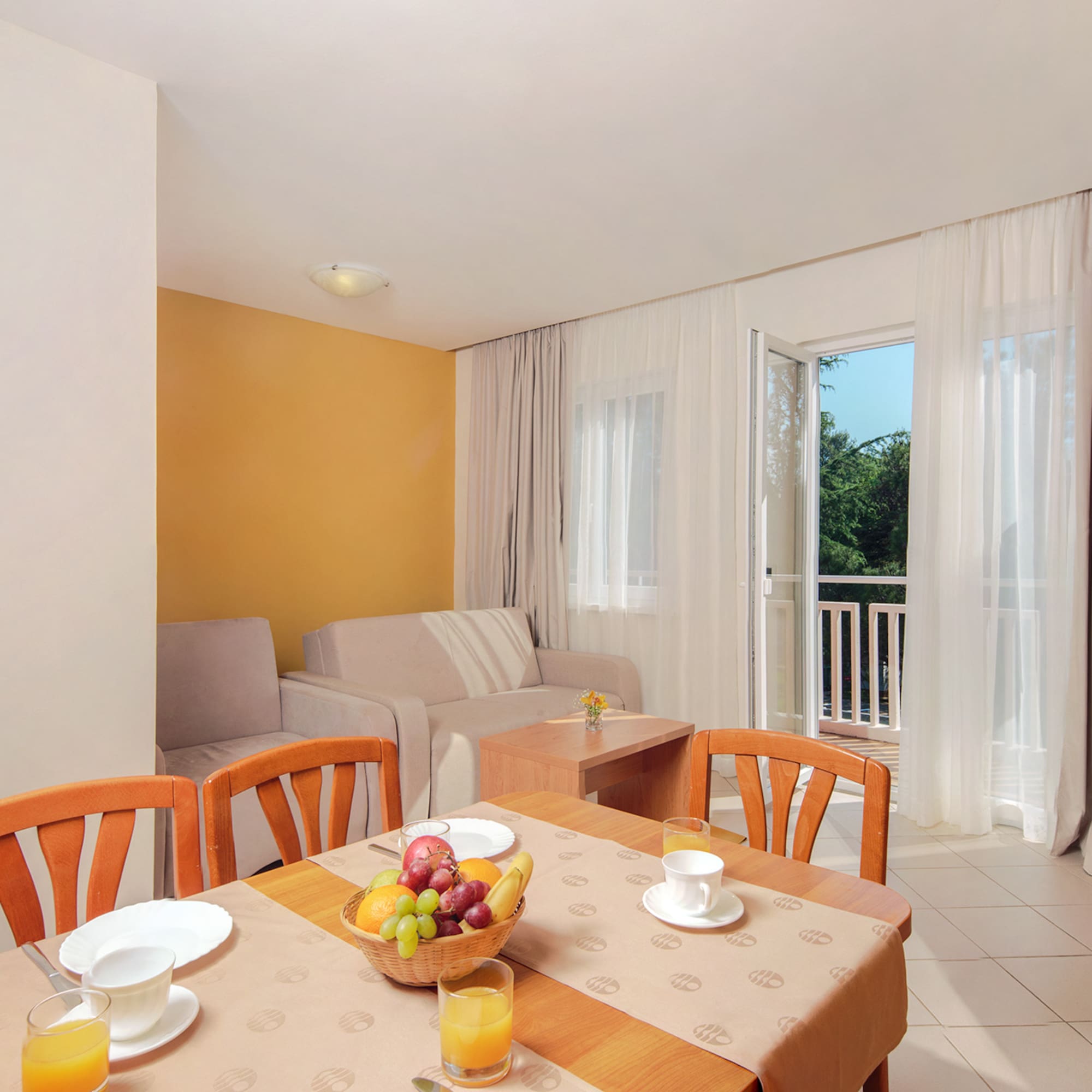 a room with a table and chairs and a couch