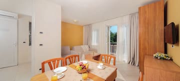 a room with a table and chairs and a couch