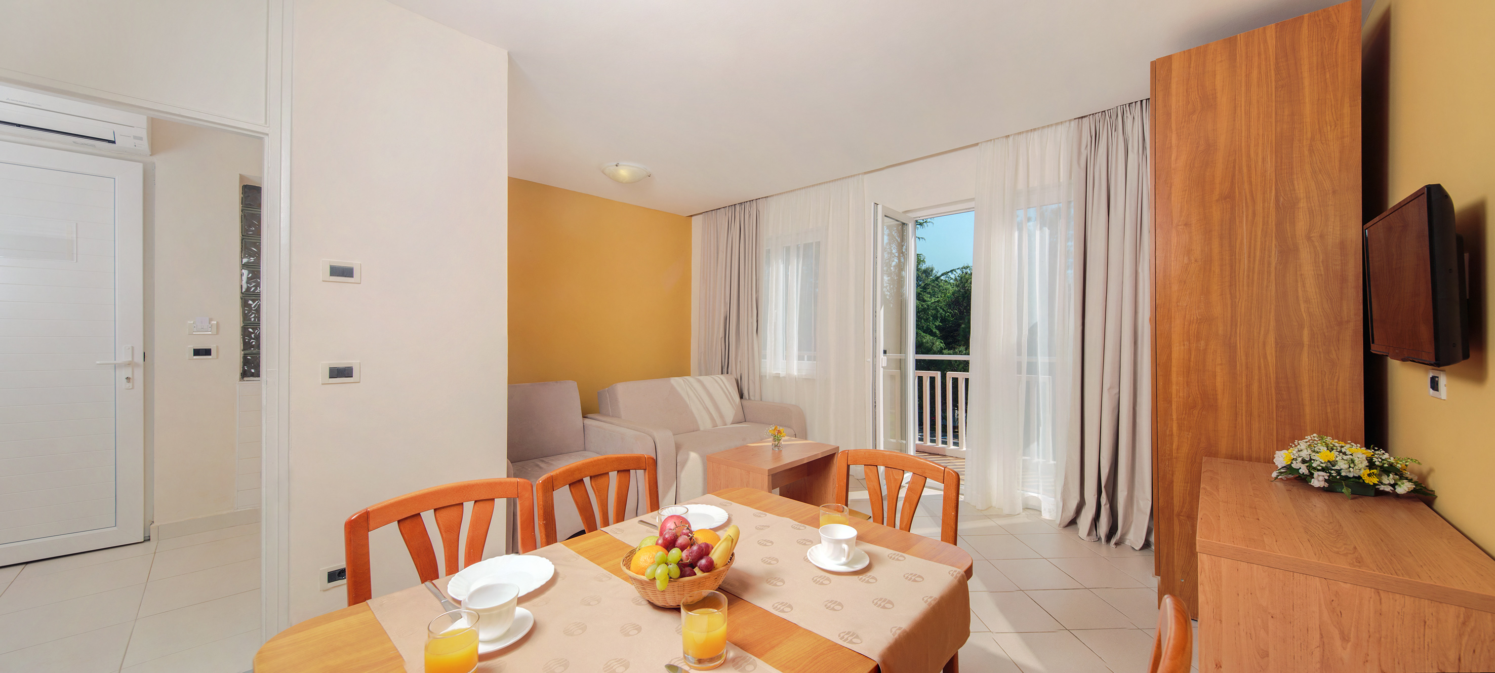a room with a table and chairs and a couch