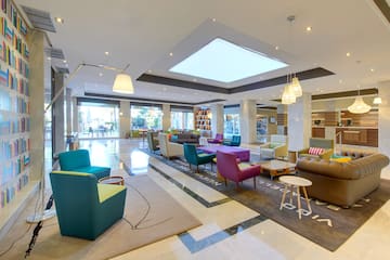 a room with colorful chairs and a large ceiling