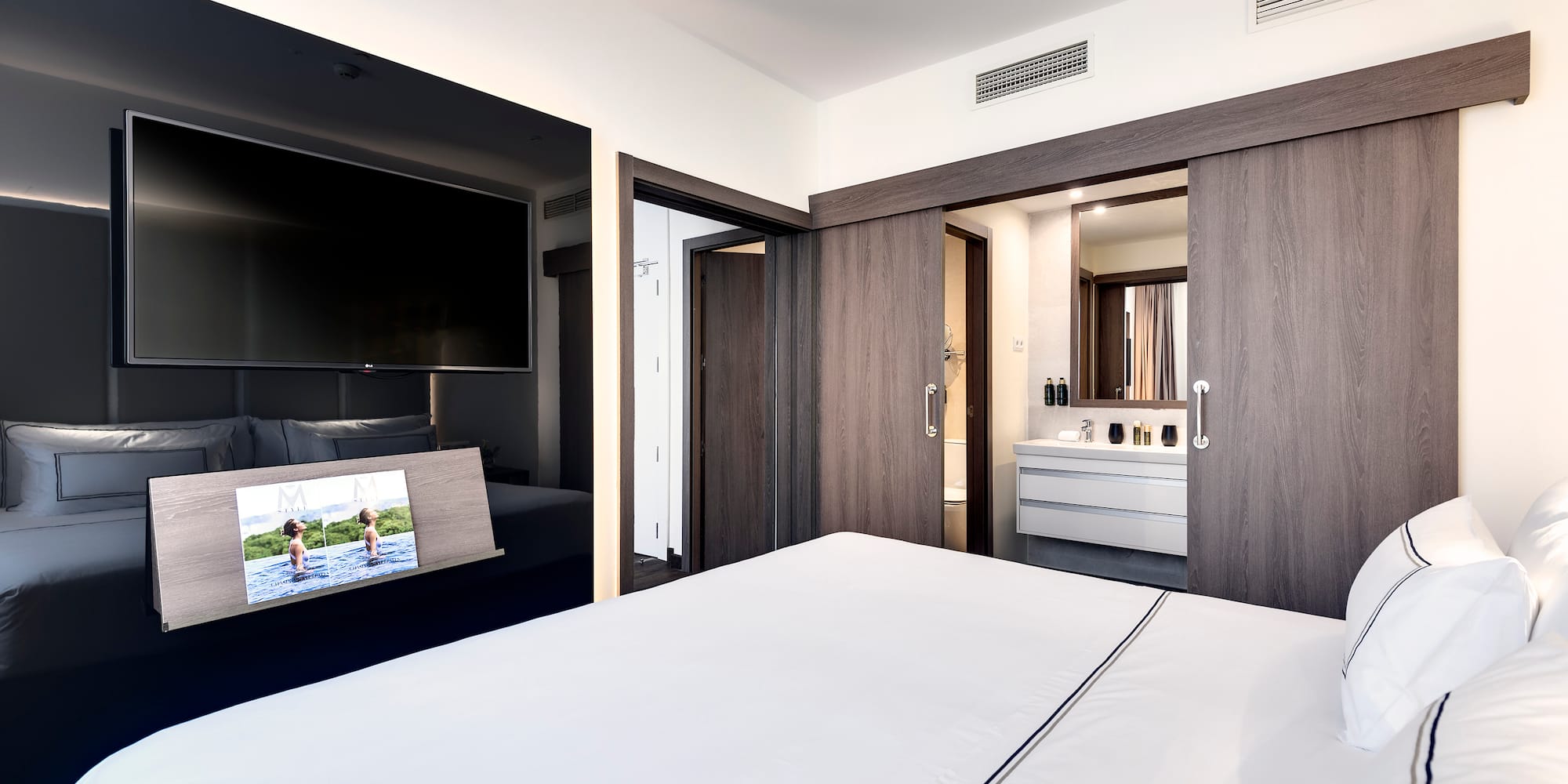 a bedroom with a television and a bed