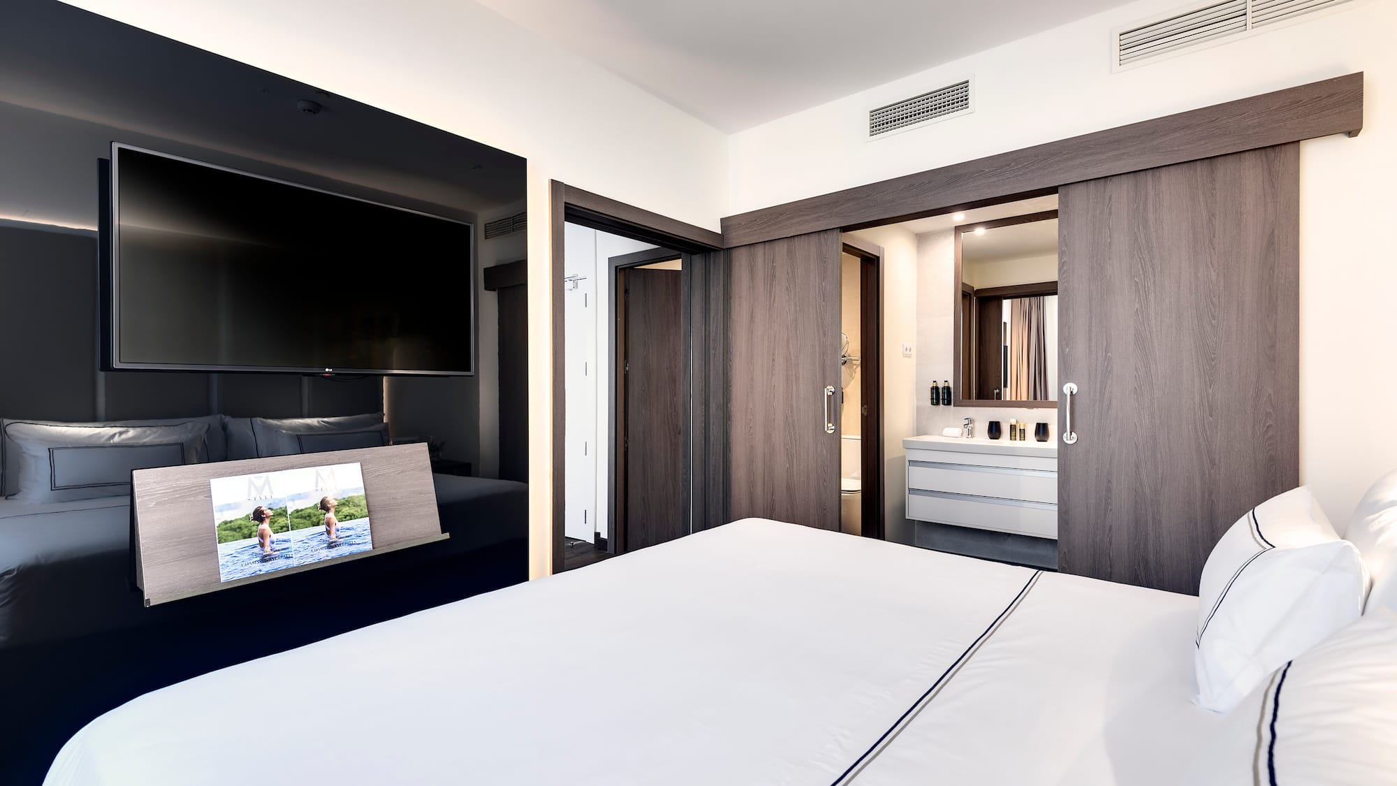 a bedroom with a television and a bed