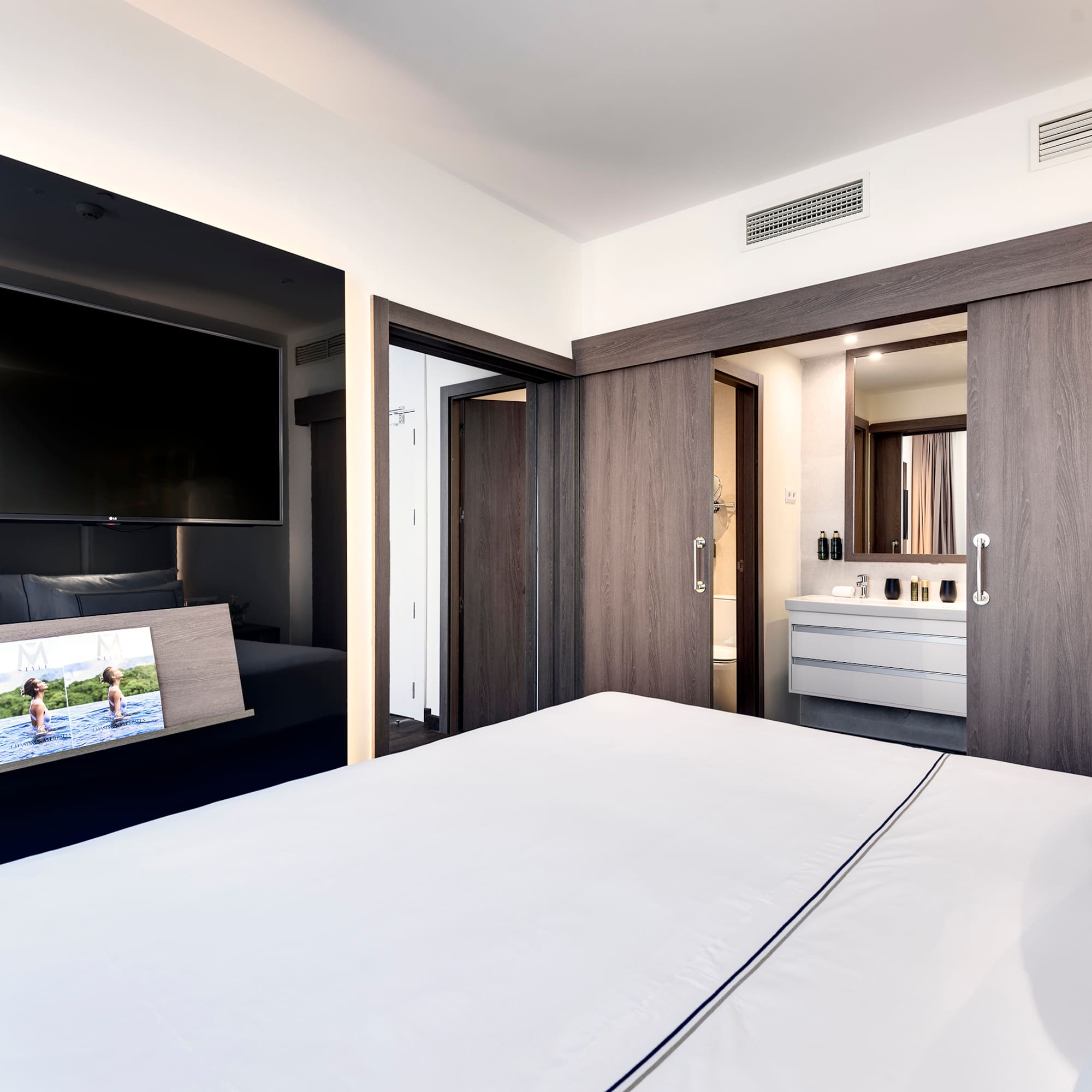 a bedroom with a television and a bed