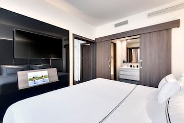 a bedroom with a television and a bed