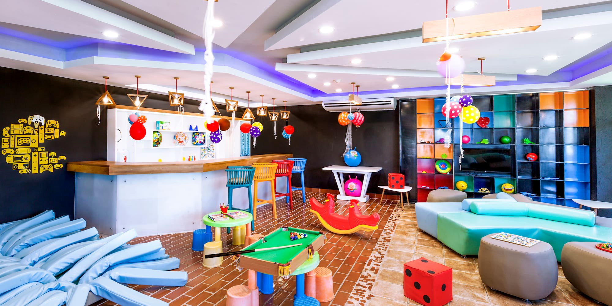 a room with colorful balloons and a pool table