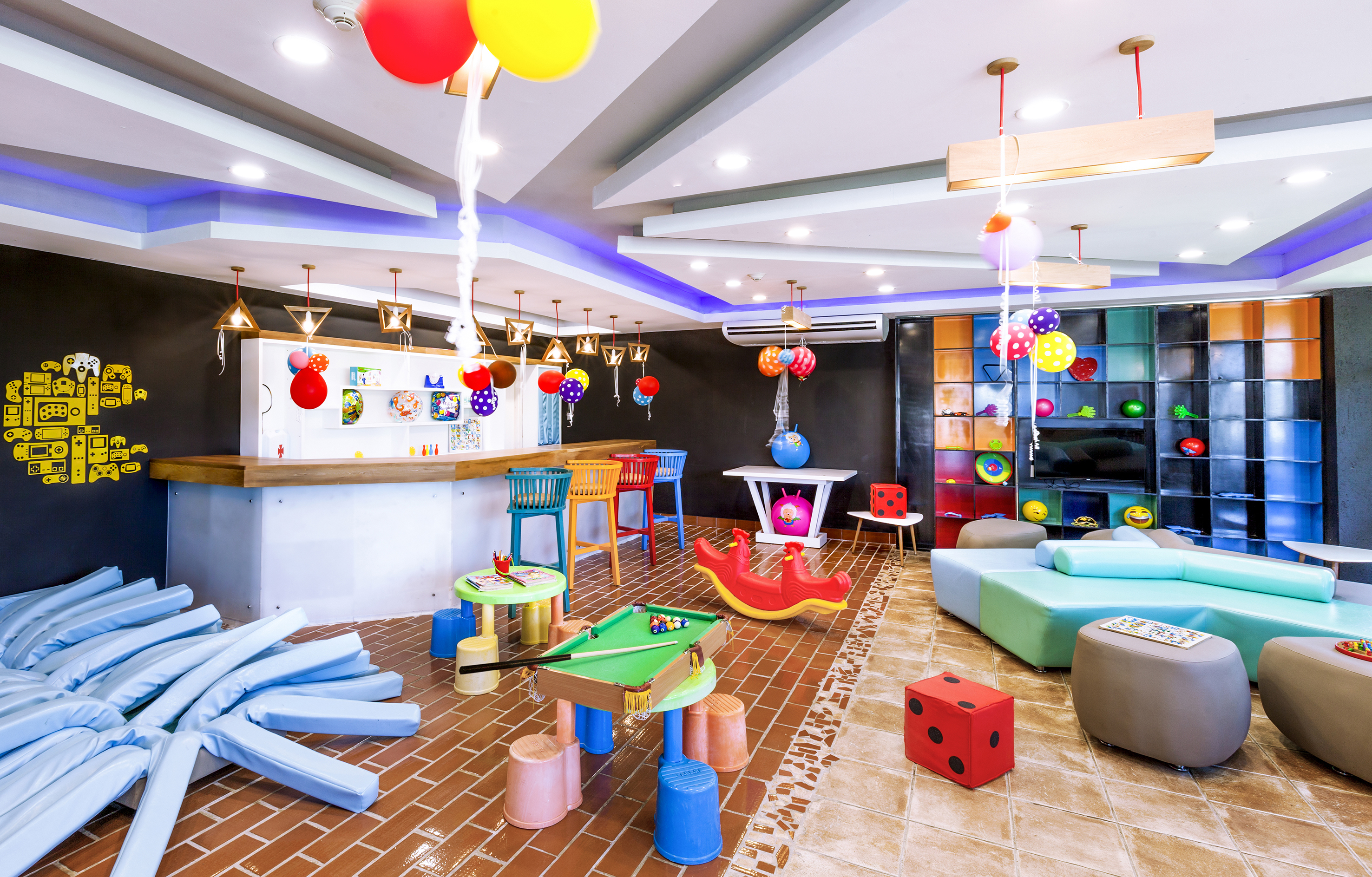 a room with colorful balloons and a pool table