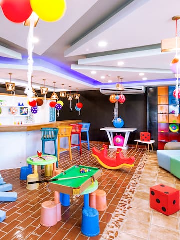 a room with colorful balloons and a pool table