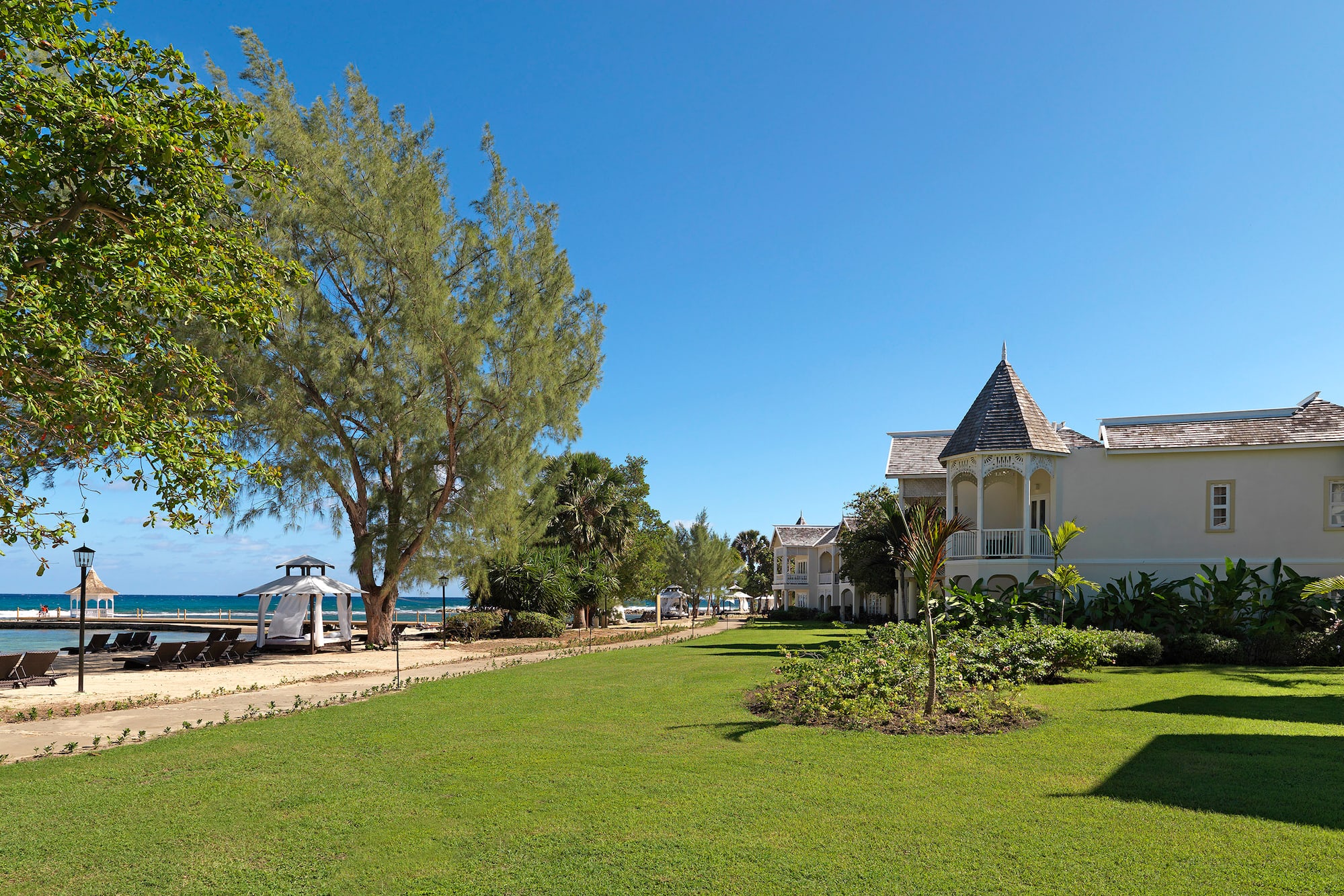 a lawn with trees and a building in the background