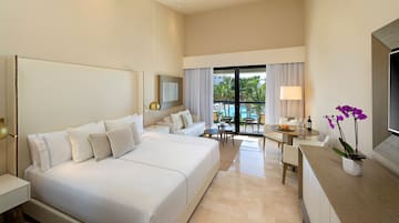 a room with a bed and a table and chairs