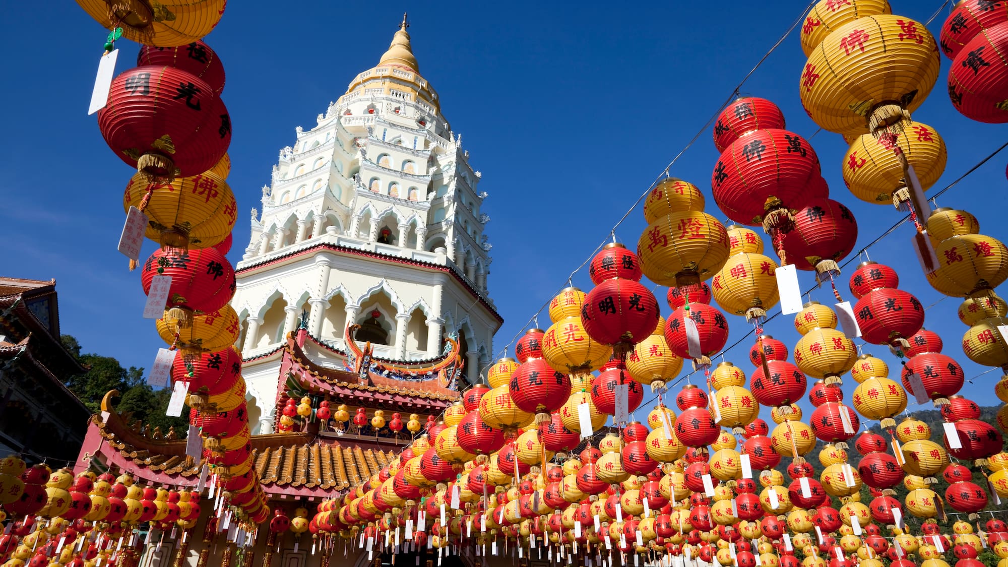 a building with a tower and red and yellow lanterns
