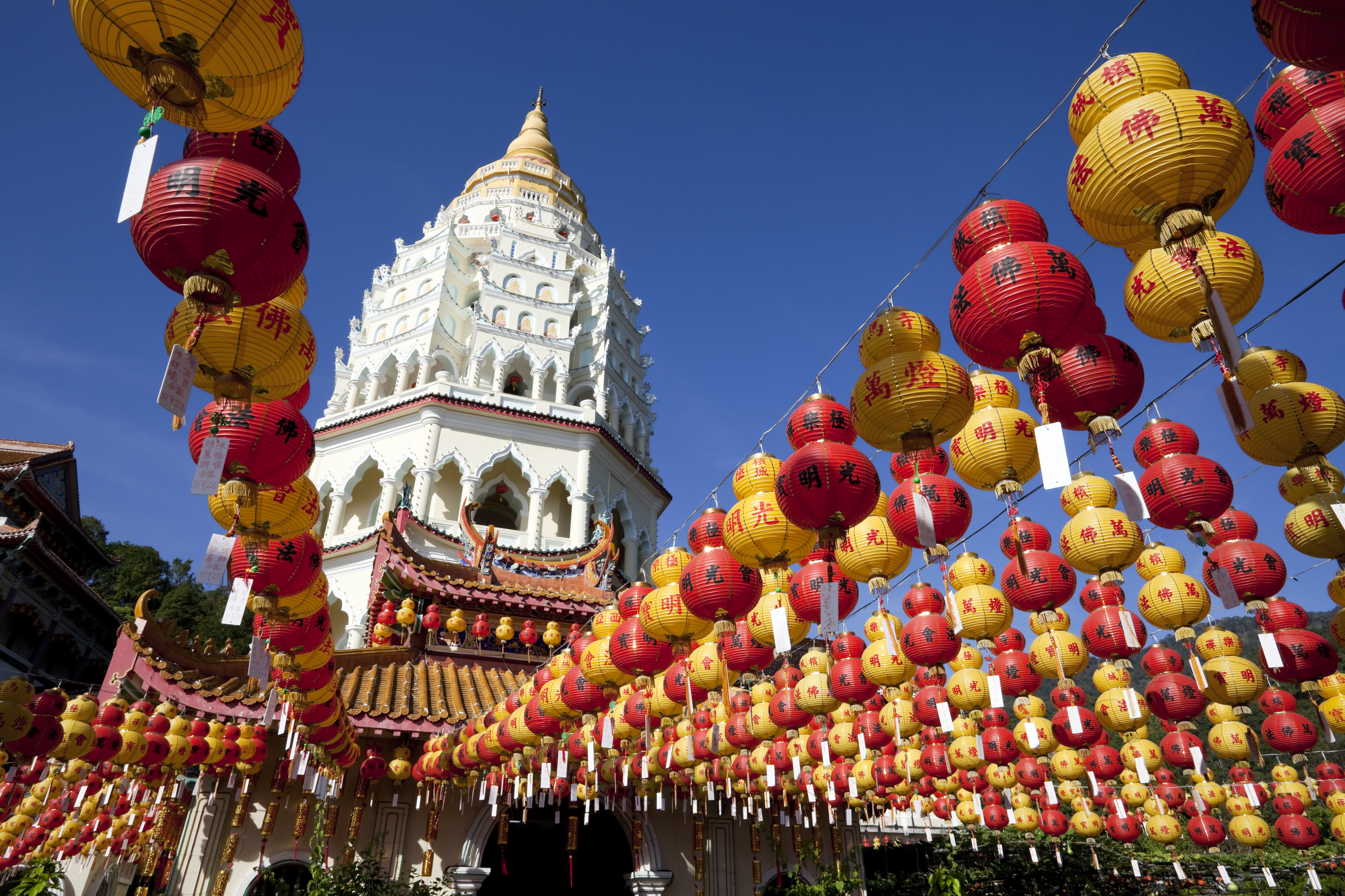 a building with a tower and red and yellow lanterns