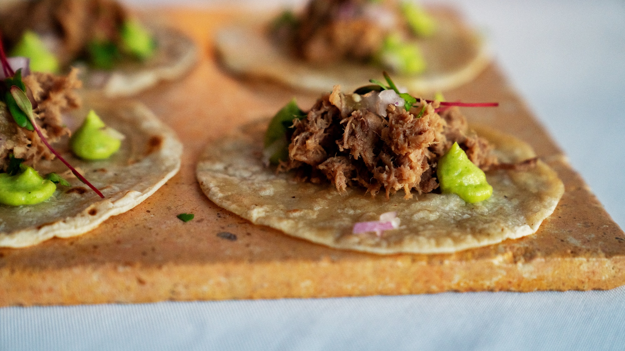 a group of tortillas with meat on top
