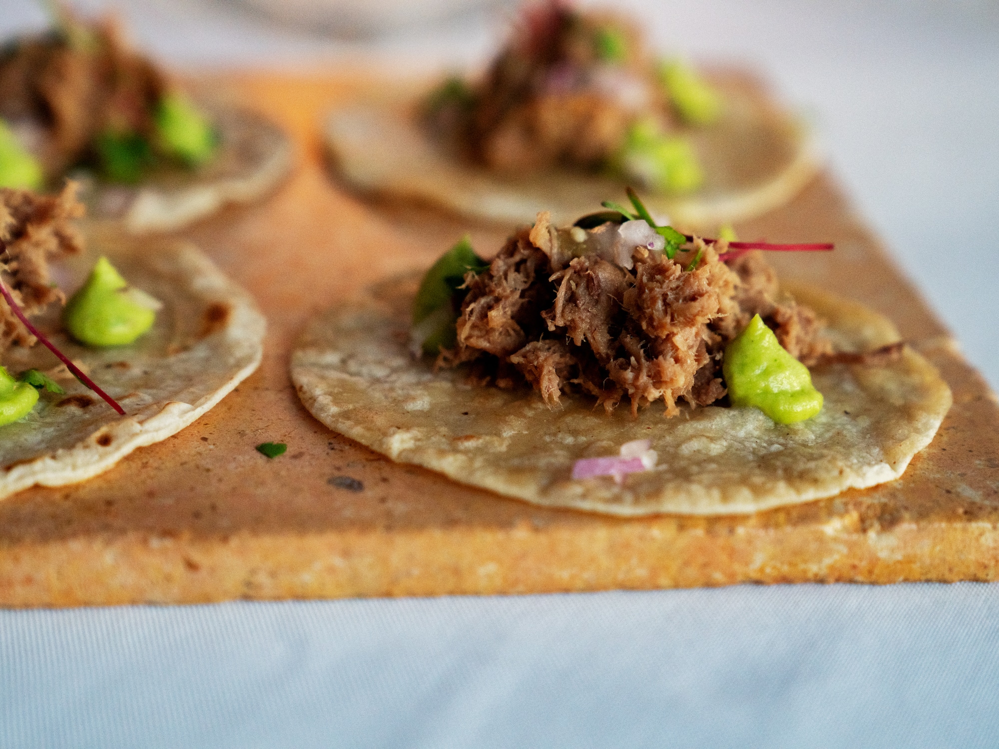 a group of tortillas with meat on top