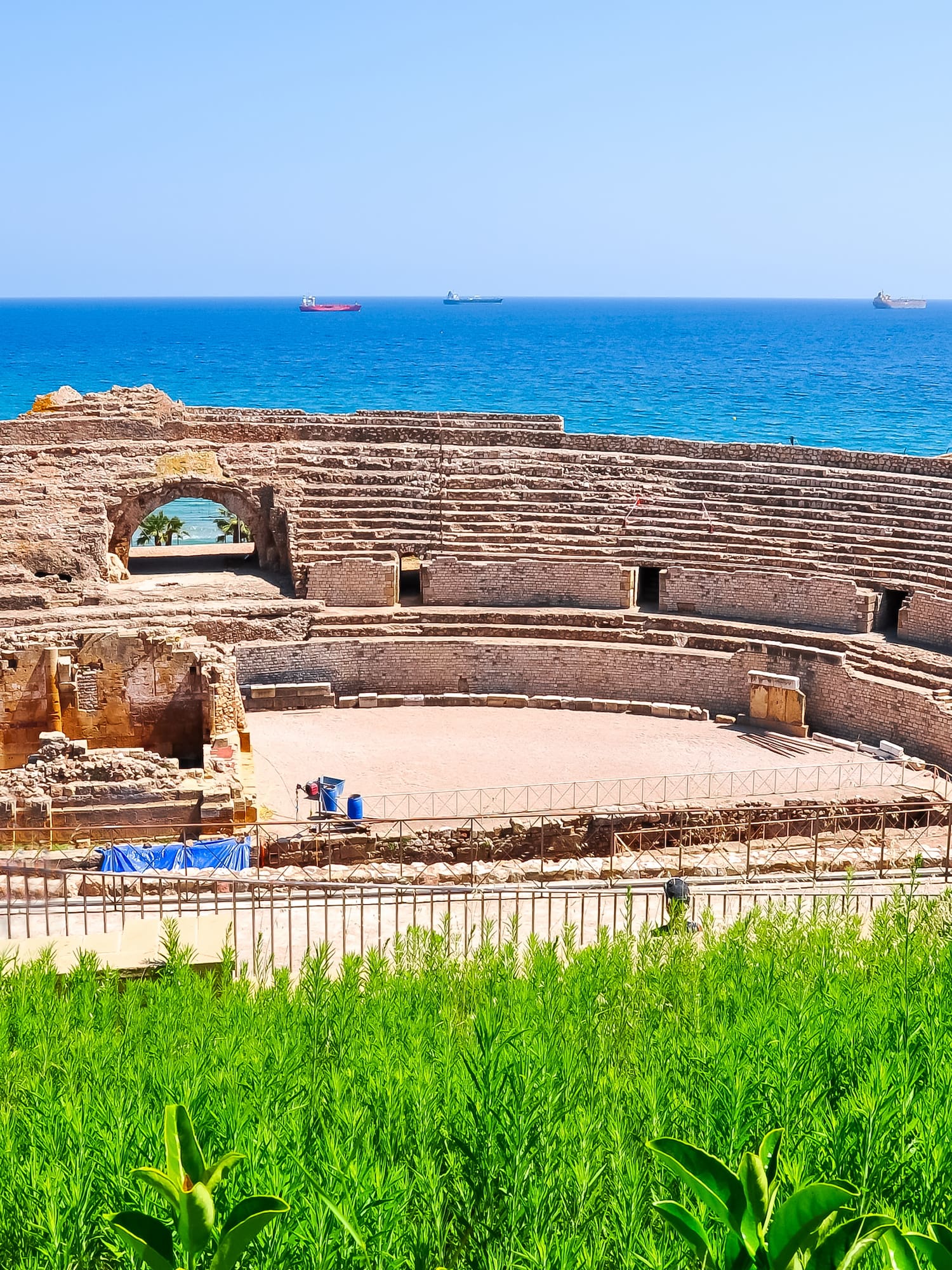an old stone structure with a body of water in the background