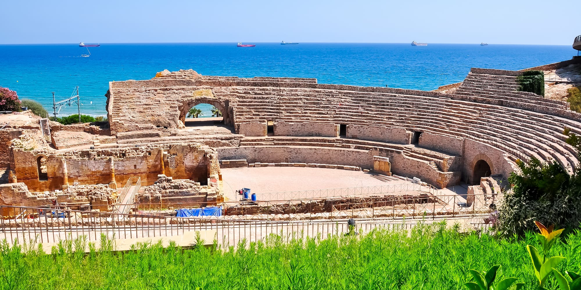 an old stone structure with a body of water in the background