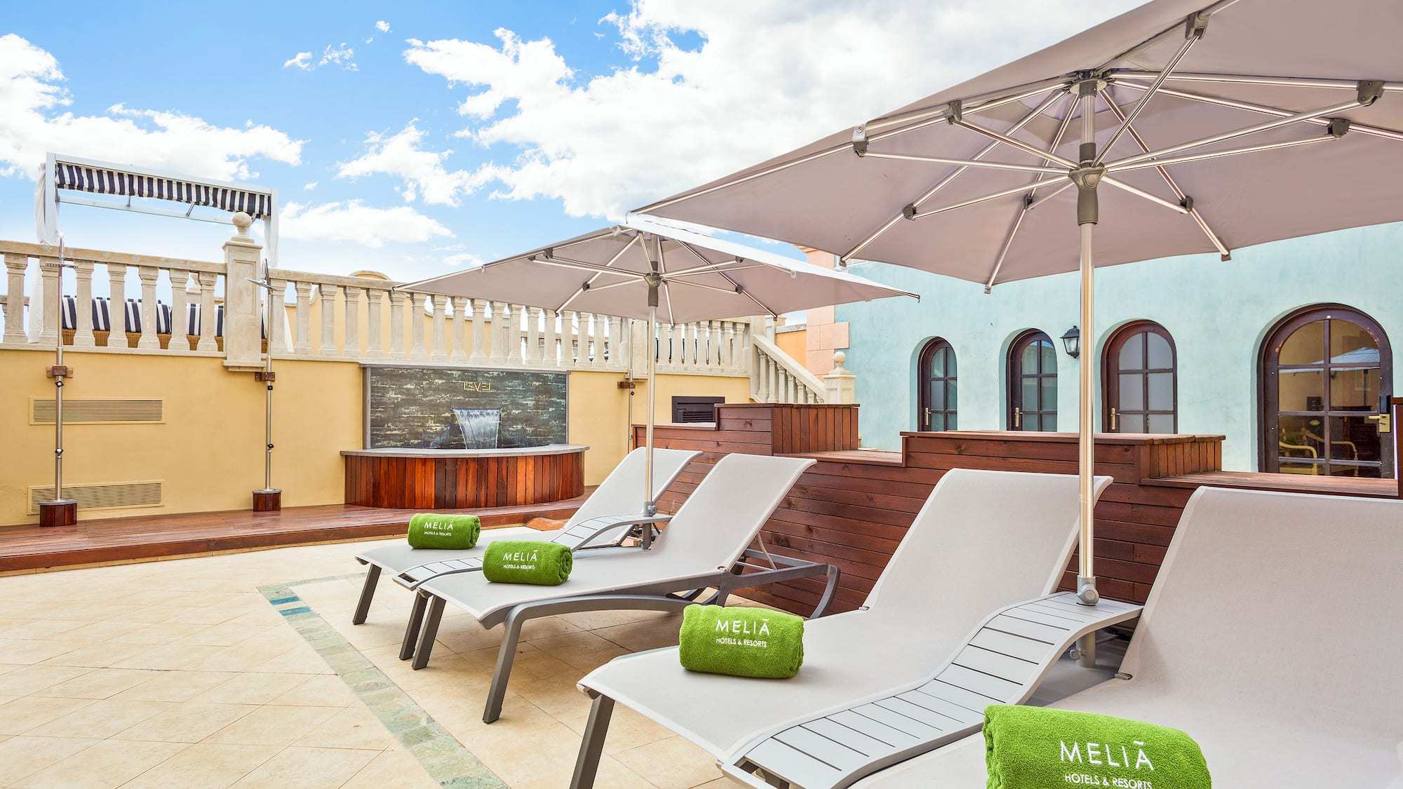 a group of chairs and umbrellas on a rooftop