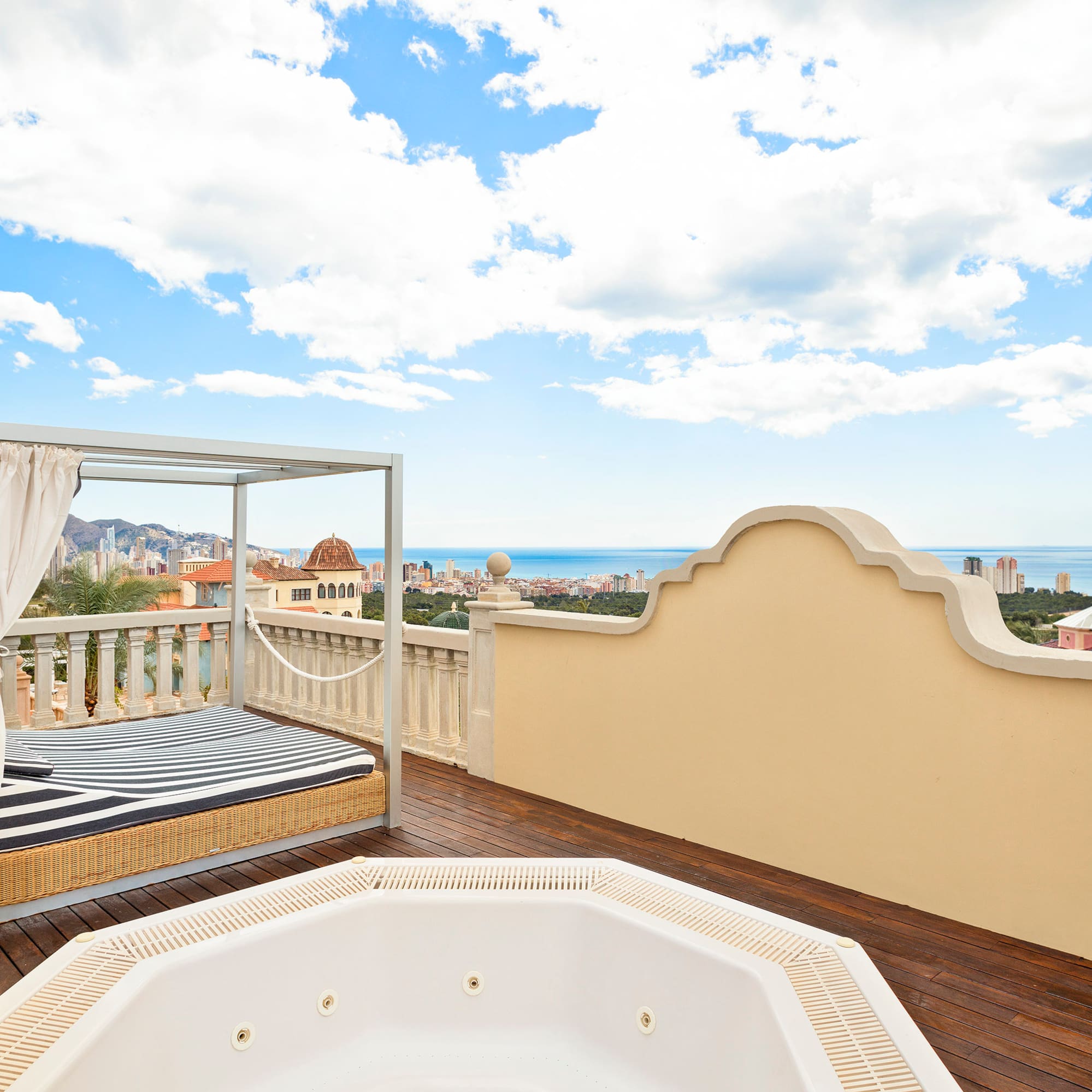 a hot tub on a deck overlooking a city