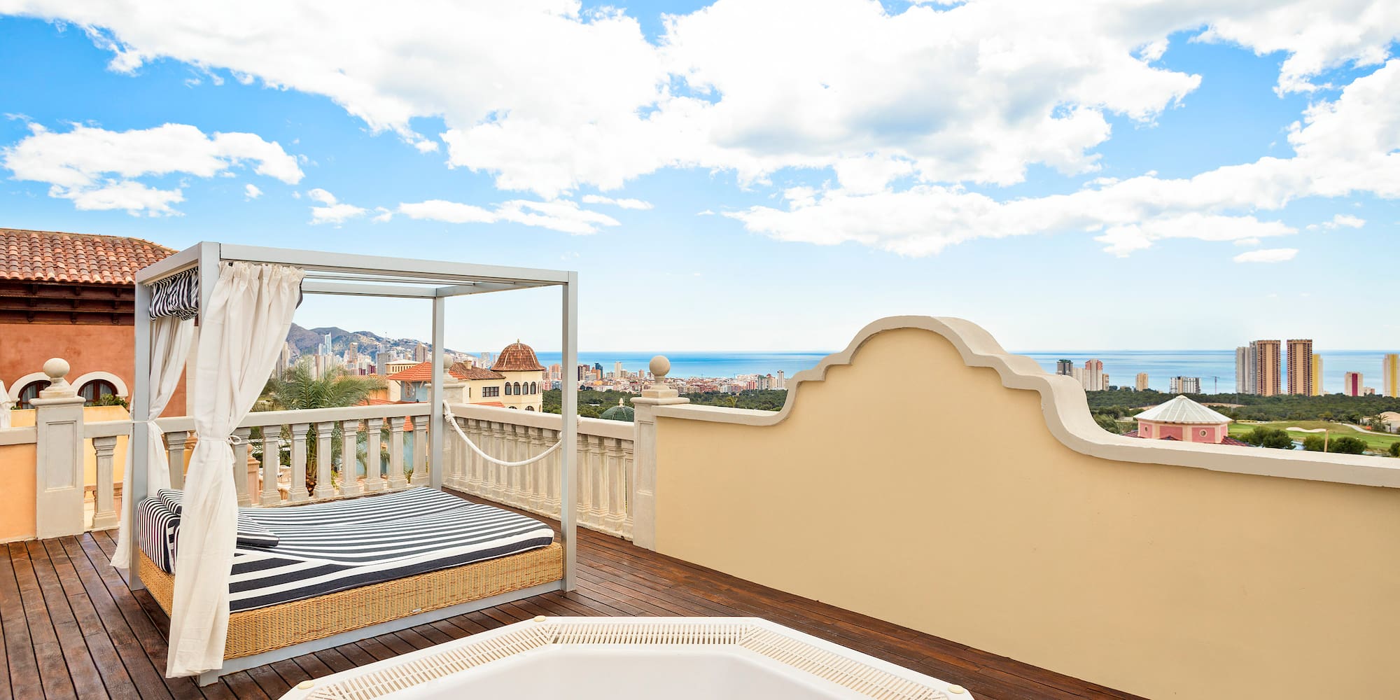 a hot tub on a deck overlooking a city
