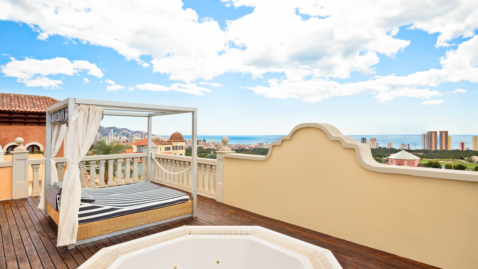 a hot tub on a deck overlooking a city