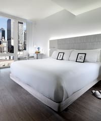 a bedroom with a large bed and a window