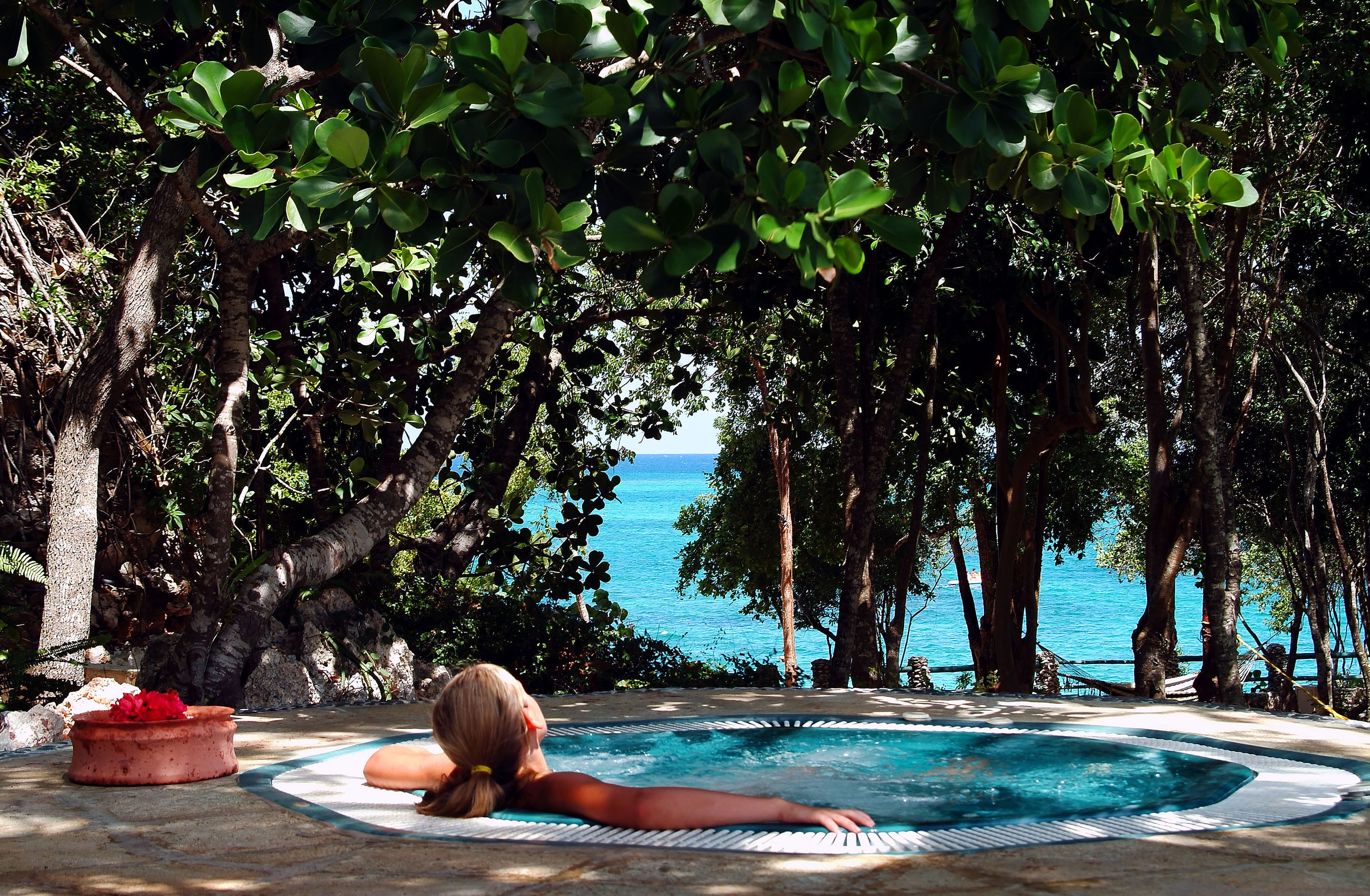 a woman in a hot tub by the water