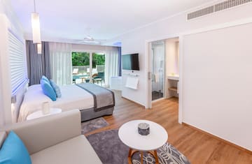 a bedroom with a bed and a television