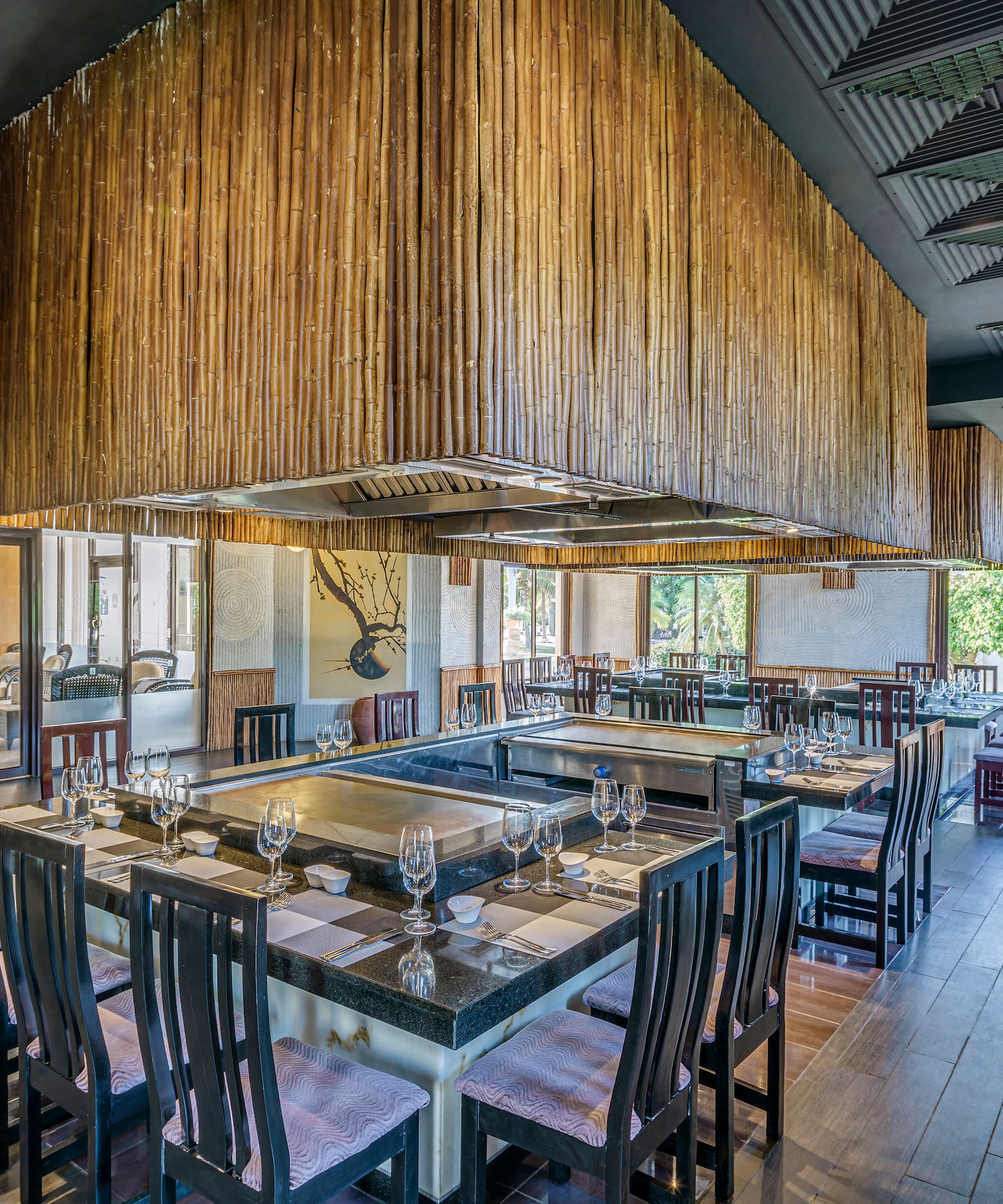 a restaurant with a large table and chairs