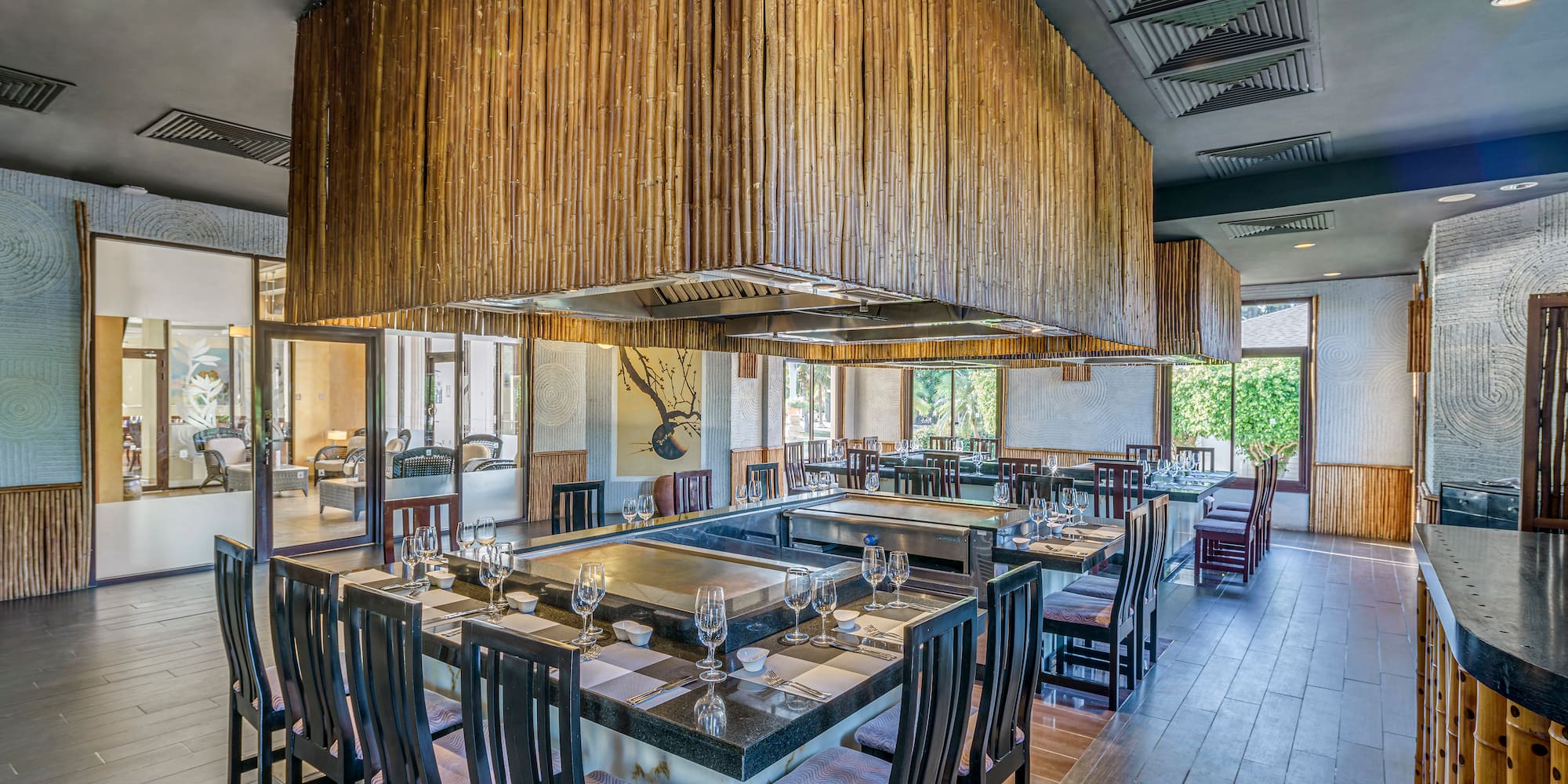 a restaurant with a large table and chairs
