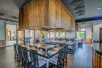 a restaurant with a large table and chairs