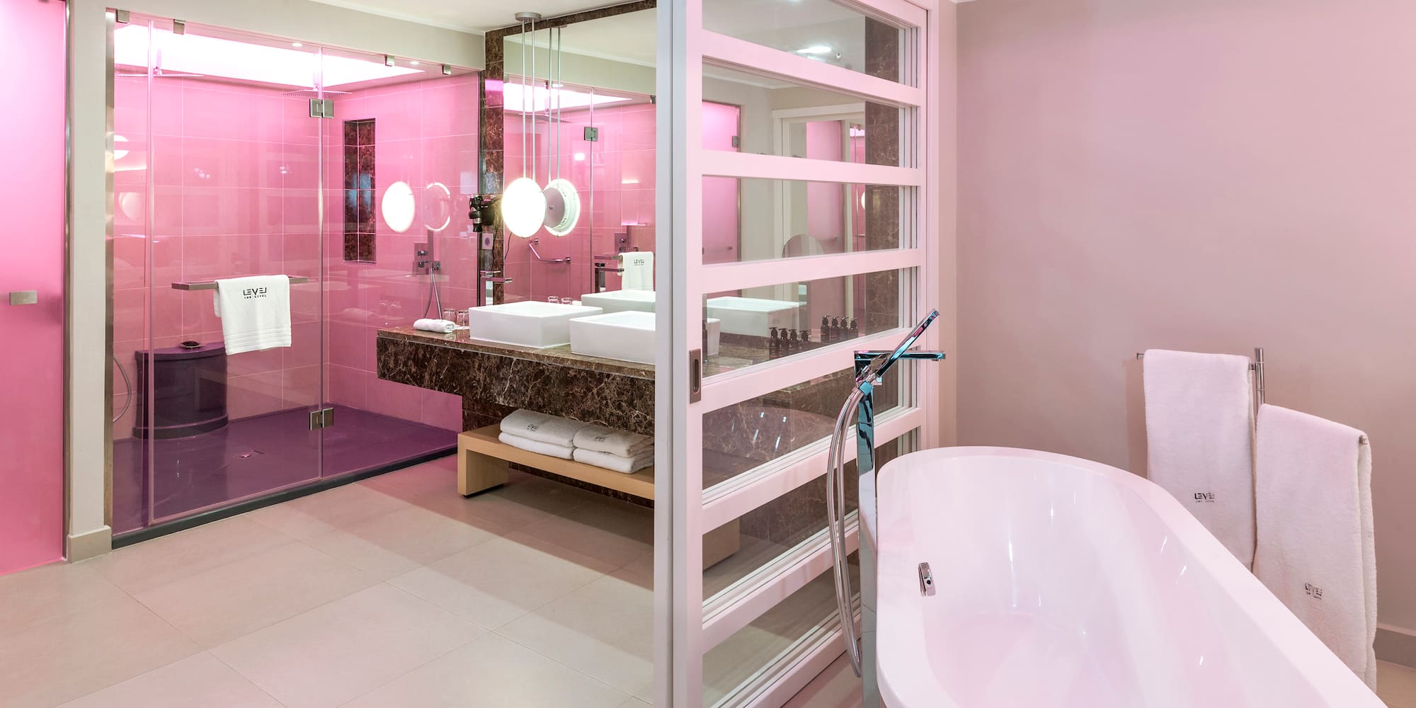 a bathroom with pink walls and a tub