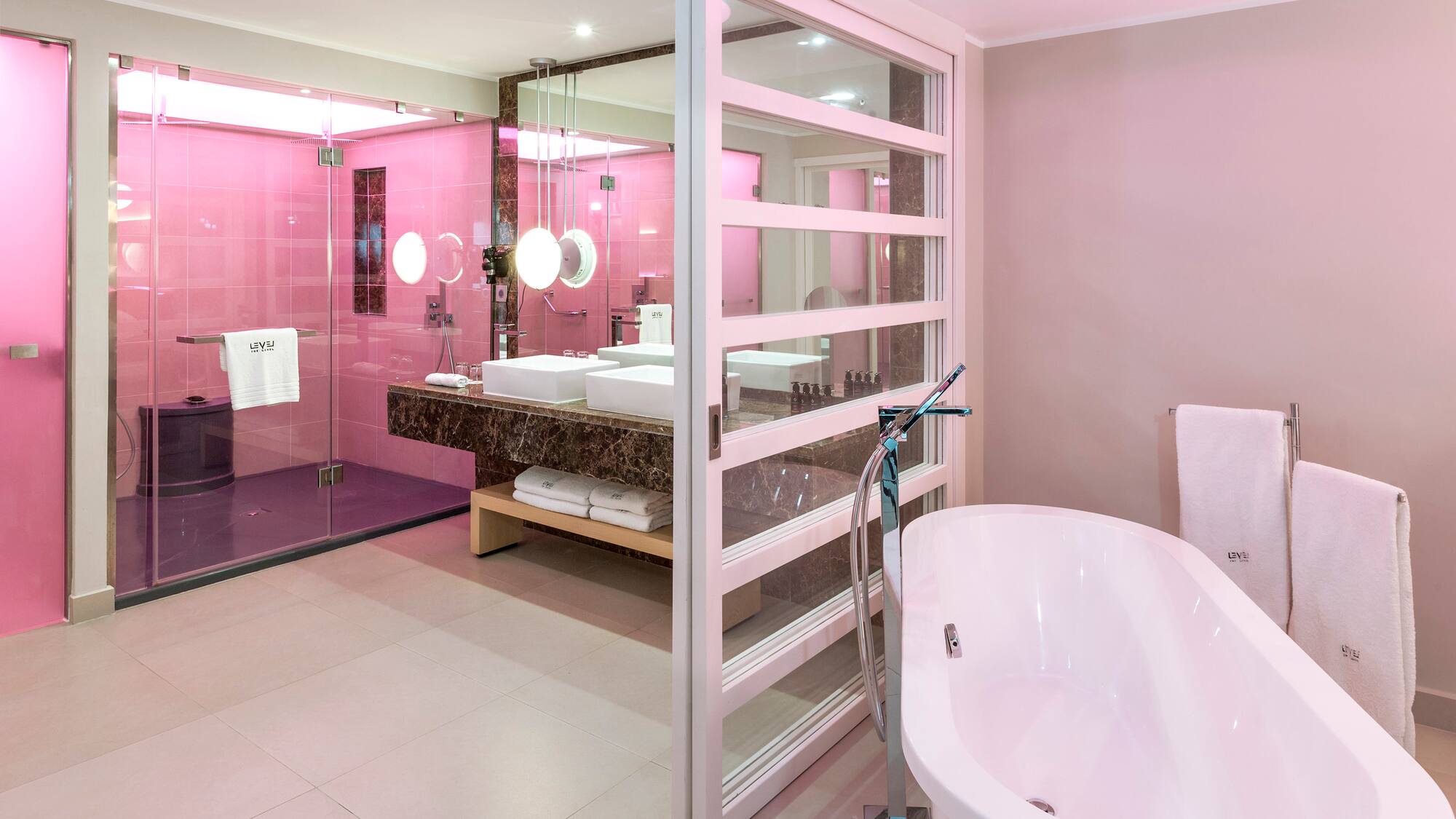 a bathroom with pink walls and a tub