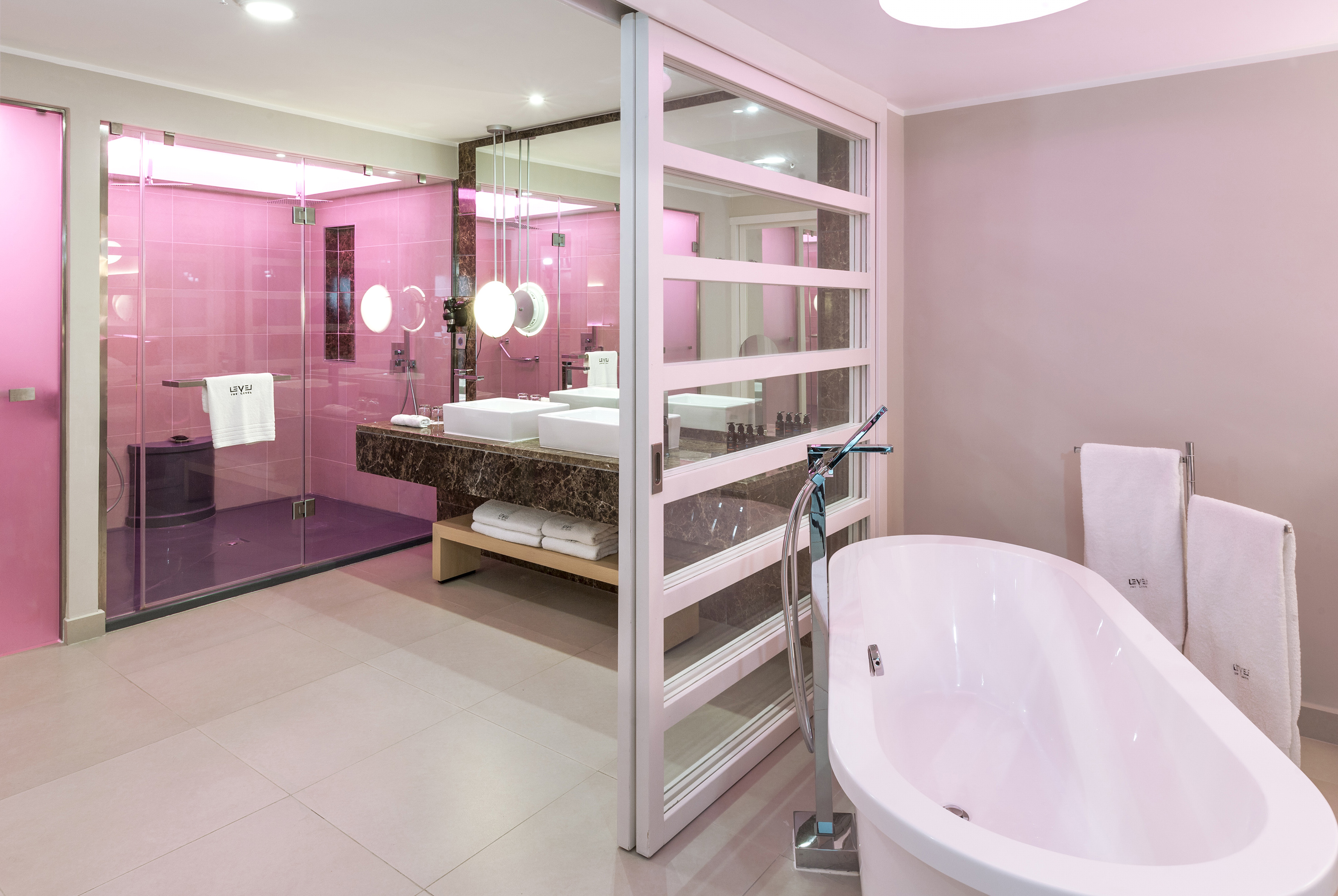 a bathroom with pink walls and a tub